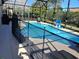 An enclosed pool area with a -safe fence and tall trees for shade at 8130 Yellow Crane Dr, Kissimmee, FL 34747