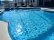This in-ground pool has crystal clear water, a basketball hoop, and lounge chairs at 8130 Yellow Crane Dr, Kissimmee, FL 34747