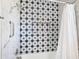 This tiled shower has a mosaic star pattern, chrome hardware, and a shower caddy at 8130 Yellow Crane Dr, Kissimmee, FL 34747