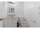 Bright bathroom featuring a white vanity, toilet, and light fixtures at 870 Darwin Dr, Altamonte Springs, FL 32701