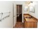 Bathroom featuring a copper sink with a wood vanity and a view into the hallway at 933 Southern Oak Ln, Apopka, FL 32712