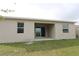 Exterior view of the home's backyard with a patio at 953 Waterfall Blvd, Davenport, FL 33837