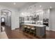 Modern kitchen featuring white cabinets, stainless steel appliances, and a gray island with seating at 10420 Royal Cypress Way, Orlando, FL 32836