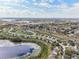 Serene community view features homes near a pond, highlighted by bright skies and landscape at 11434 Wishing Well Ln, Clermont, FL 34711