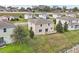 Aerial view of the house with a wooden deck overlooking the grassy backyard at 11434 Wishing Well Ln, Clermont, FL 34711
