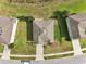 Birds eye view of a single Gathering home with well-manicured lawn and concrete driveway in a residential neighborhood at 11434 Wishing Well Ln, Clermont, FL 34711