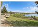 Expansive backyard overlooking a picturesque lake and lush greenery at 11434 Wishing Well Ln, Clermont, FL 34711