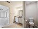 Bathroom with double vanity sinks and a separate toilet room at 11434 Wishing Well Ln, Clermont, FL 34711