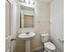 Powder room with pedestal sink, toilet, and tiled floor at 11434 Wishing Well Ln, Clermont, FL 34711