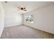 Bright bedroom featuring two windows and neutral carpet at 11434 Wishing Well Ln, Clermont, FL 34711