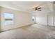 Bright bedroom featuring two windows and a ceiling fan at 11434 Wishing Well Ln, Clermont, FL 34711