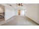 Spacious carpeted bedroom with ceiling fan and tray ceiling at 11434 Wishing Well Ln, Clermont, FL 34711