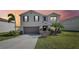 Charming two-story home with a well-manicured lawn and neutral stucco exterior under a colorful sunset at 11434 Wishing Well Ln, Clermont, FL 34711