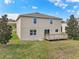 Back of the house with a wooden deck overlooking the grassy backyard at 11434 Wishing Well Ln, Clermont, FL 34711