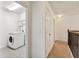 Hallway leading to laundry room featuring neutral tones and lighting at 11434 Wishing Well Ln, Clermont, FL 34711