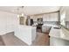 Kitchen with modern appliances, light cabinets, backsplash and a breakfast bar at 11434 Wishing Well Ln, Clermont, FL 34711
