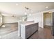 Kitchen view into living room with tile floors and island with white countertop at 11434 Wishing Well Ln, Clermont, FL 34711