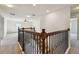 Upstairs landing featuring decorative iron railing at 11434 Wishing Well Ln, Clermont, FL 34711