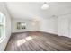 Bright living room with luxury vinyl plank flooring and large windows at 11434 Wishing Well Ln, Clermont, FL 34711