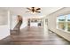 Sun-drenched living room with open floor plan leading to a modern kitchen at 11434 Wishing Well Ln, Clermont, FL 34711