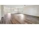 Spacious living room featuring luxury vinyl plank flooring and abundant natural light at 11434 Wishing Well Ln, Clermont, FL 34711