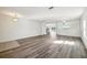 Open living room area showcasing updated flooring and a staircase to the second floor at 11434 Wishing Well Ln, Clermont, FL 34711