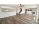 Spacious open-concept living room showing stairs, kitchen, and luxury vinyl flooring at 11434 Wishing Well Ln, Clermont, FL 34711