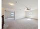 Loft with carpeted floors, ceiling fan, and access to multiple rooms at 11434 Wishing Well Ln, Clermont, FL 34711