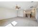 Loft with carpeted floors, ceiling fan, and access to multiple rooms and staircase at 11434 Wishing Well Ln, Clermont, FL 34711