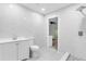 Renovated bathroom boasts marble look tile and modern fixtures at 1211 Dorothy St, Lakeland, FL 33815