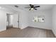 The bright room features wood-look floors and a ceiling fan at 1211 Dorothy St, Lakeland, FL 33815