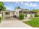 The home features a connected carport and partially screened porch at 1211 Dorothy St, Lakeland, FL 33815