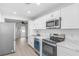Modern kitchen boasts stainless steel appliances and white cabinetry at 1211 Dorothy St, Lakeland, FL 33815