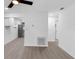 Open-concept living area with wood-look flooring, leading into kitchen at 1211 Dorothy St, Lakeland, FL 33815