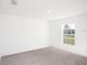 Bright bedroom with neutral carpeting and large window at 1270 3Rd W St, Orange City, FL 32763