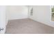 Spacious bedroom with neutral carpeting and two windows at 1270 3Rd W St, Orange City, FL 32763