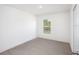 Bright bedroom with neutral carpeting and window at 1270 3Rd W St, Orange City, FL 32763