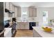 Modern kitchen with gray cabinets, stainless steel appliances, and an island at 1270 3Rd W St, Orange City, FL 32763