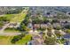 Aerial view of the home showing the neighborhood, close proximity to local green spaces, and tree lined streets at 12918 Hunters Vista Blvd, Orlando, FL 32837