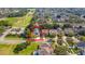 Aerial view of the home, showcasing it's location in a tree lined neighborhood near a large green space at 12918 Hunters Vista Blvd, Orlando, FL 32837