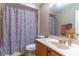 Bathroom with a decorative shower curtain, vanity, and mirror at 12918 Hunters Vista Blvd, Orlando, FL 32837