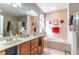 Relaxing bathroom featuring double sinks, soaking tub, and walk-in shower at 12918 Hunters Vista Blvd, Orlando, FL 32837