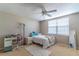 Bedroom featuring a ceiling fan, window with blinds, and small workspace area at 12918 Hunters Vista Blvd, Orlando, FL 32837