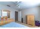 Bright bedroom featuring neutral tones, a ceiling fan, and wood furnishings at 12918 Hunters Vista Blvd, Orlando, FL 32837