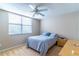 Simple bedroom featuring neutral tones, a ceiling fan, and a window with blinds at 12918 Hunters Vista Blvd, Orlando, FL 32837