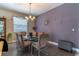 Elegant dining room with modern glass table, stylish chairs, and decorative wall art at 12918 Hunters Vista Blvd, Orlando, FL 32837