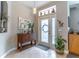 Bright entryway featuring tiled floor, cabinet, stylish lighting, and decorative wall art at 12918 Hunters Vista Blvd, Orlando, FL 32837