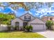 Charming single Gathering home featuring well-maintained landscaping and a paved driveway at 12918 Hunters Vista Blvd, Orlando, FL 32837