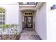 Close up of the front door with stone walkway and decorative shrubbery and 'Welcome' sign at 12918 Hunters Vista Blvd, Orlando, FL 32837