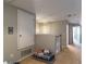 Hallway with an access door and view into an adjacent room with natural light at 12918 Hunters Vista Blvd, Orlando, FL 32837
